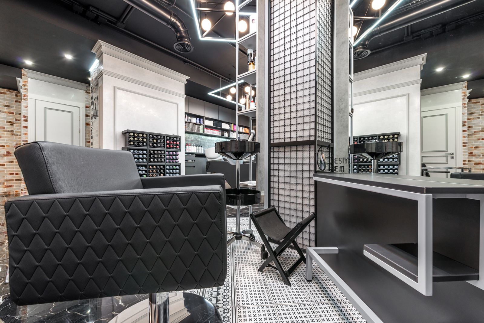 Contemporary and sophisticated barber shop interior with stylish furniture and lighting.